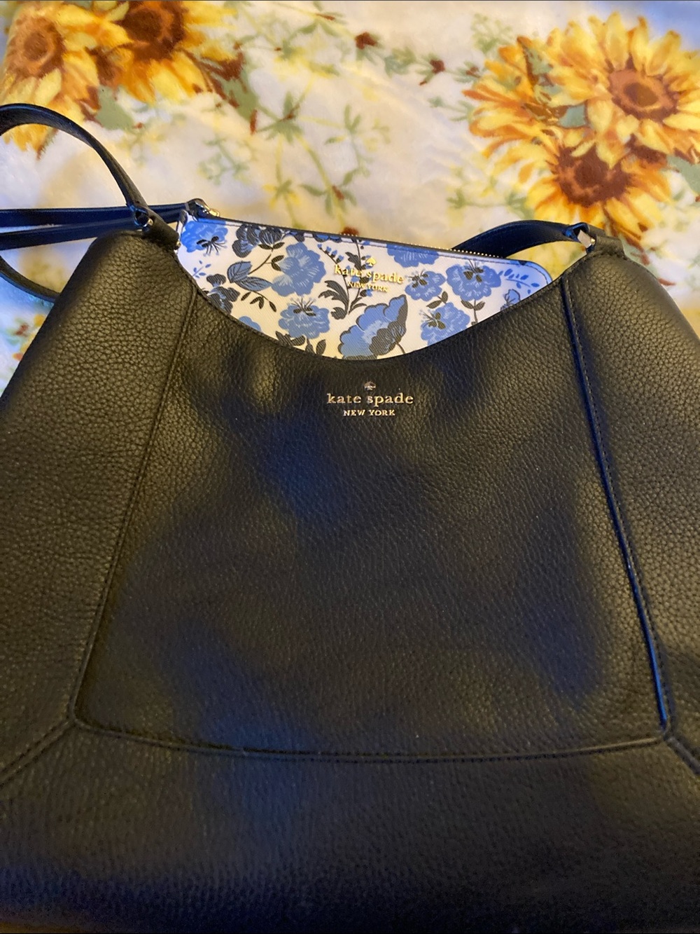 kate spade Black Pebbled Leather Shoulder Bag with a blue floral clutch inclucde